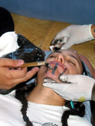 California Tattoo Renaissance. Keone Nunes tattooing a Yurok Woman, 2002. Photograph courtesy of Keone Nunes.